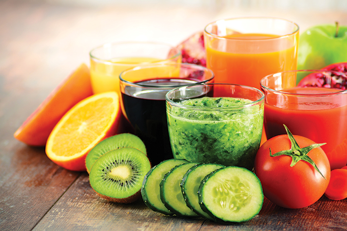 Fruits and vegetable juices in glasses depicting getting the vitamin therapy needed to feel better
